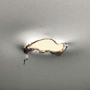 I'm pretty sure someone used a pick axe to add this hole Detail of hole