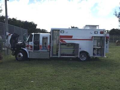 Driver's side of truck with all doors and lockers open Truck